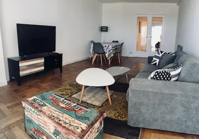 a living room with a couch and a table at Large flat terrace Sea view, Promenade des Anglais in Nice