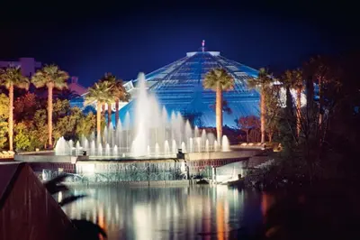 a fountain in front of a building with palm trees at Large flat terrace Sea view, Promenade des Anglais in Nice