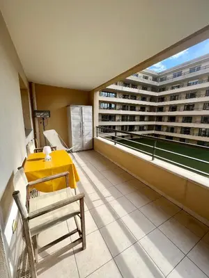 a balcony with a table and chairs in a building at Studio Palais de la Méditerranée in Nice