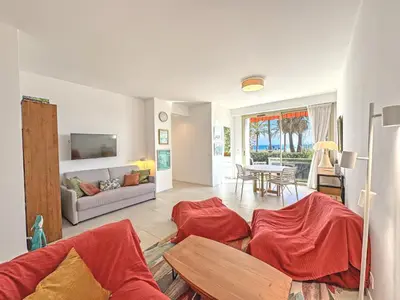 a living room with a couch and a table at Cosy Sea Front Garden Nice in Nice
