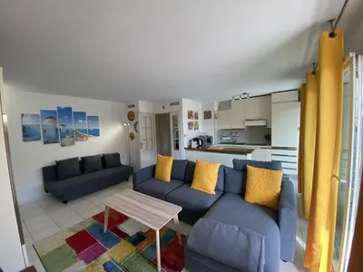 a living room with two blue couches and a table at Nice Magnan 2P-Piscine, Clim, Parking in Nice