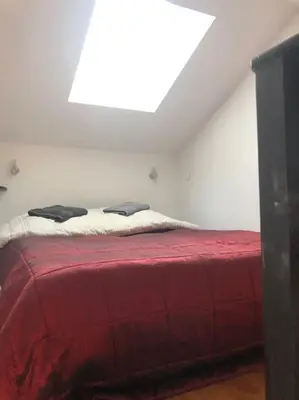 a bedroom with a bed with a red blanket at Balcony last floor harbour Nice parking on demand in Nice