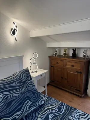 a bedroom with a bed and a dresser and a desk at Duplex proche port de Nice in Nice