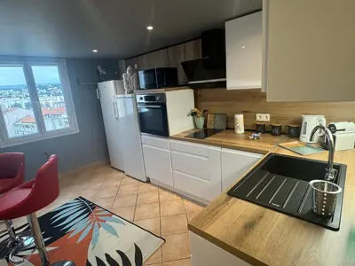 a kitchen with a white refrigerator and a counter top at Duplex proche port de Nice in Nice