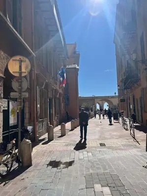 a man walking down a street in a city at 2 pièces Vieux Nice - Deux pas de la mer in Nice