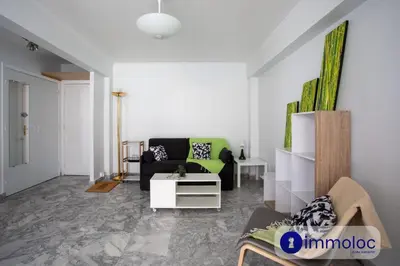 a living room with a couch and a table at Studio Air-conditioned district of the Musicians in Nice
