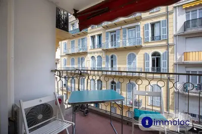 a balcony with a table in front of a building at Studio Air-conditioned district of the Musicians in Nice