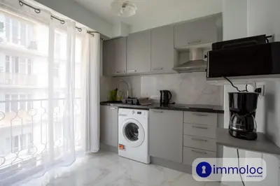 a kitchen with a washing machine and a window at Studio Air-conditioned district of the Musicians in Nice