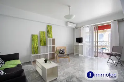 a living room with a couch and a table at Studio Air-conditioned district of the Musicians in Nice