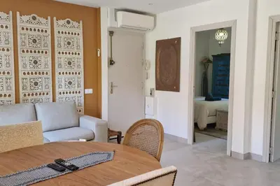 a living room with a table and a couch at Rêves d'Orient - proche mer in Nice