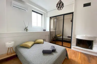 a living room with a bed and a fireplace at 06BX Loft Pessicart in Nice