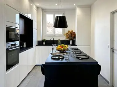 a kitchen with a table with a bowl of fruit on it at Chic Renovated Home - Nice Libération - Entire 2BR 2BA Apartment or Private Rooms with Private Bathrooms - AC and Garage on request in Nice