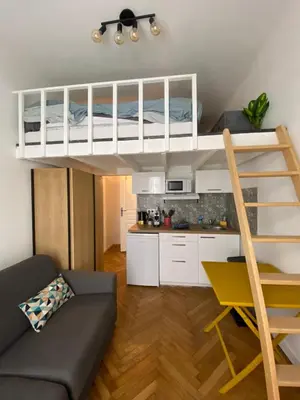 a living room with a bunk bed and a kitchen at Studio Hérold - Évasion avec Terrasse à Nice in Nice