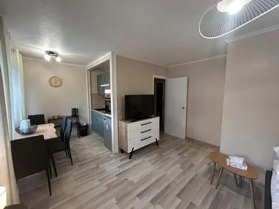 a living room with a kitchen and a dining room at Studio à deux pas de la mer in Nice