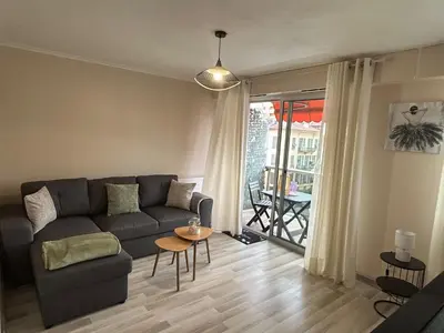 a living room with a couch and a table at Studio à deux pas de la mer in Nice