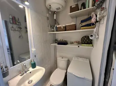 a small bathroom with a toilet and a sink at Petit studio de charme in Villefranche-sur-Mer