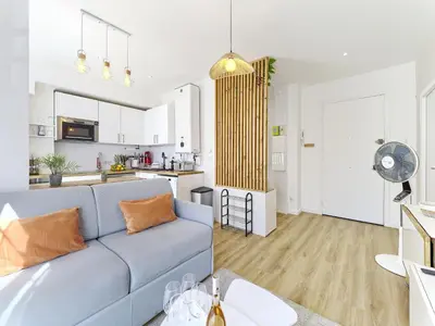 a living room with a blue couch and a kitchen at City Center - Magnificent Apartment - Cozy - Wifi in Nice