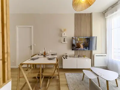 a dining room with a table and chairs and a tv at City Center - Magnificent Apartment - Cozy - Wifi in Nice