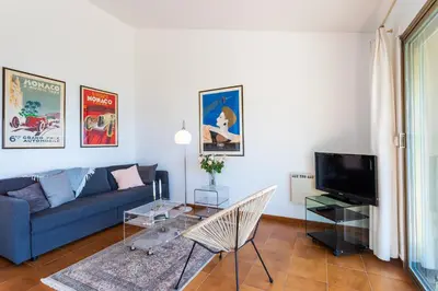a living room with a blue couch and a tv at VILLA LA PETITE RESERVE VI4416 By Riviera Holiday in Èze