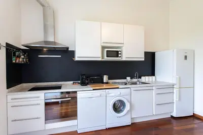 a kitchen with white cabinets and a washing machine at #27 Urban Suite AC 2 Bedrooms 10mins Walk Sea&Old Town in Nice