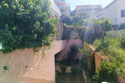 an alley way with plants in a building at Refurbished apartment with terrace and garden in Nice