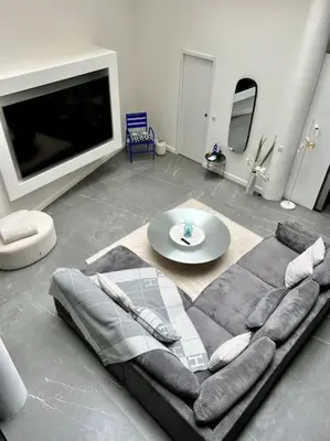 a living room with a couch and a tv at Magnifique loft au cœur de Nice in Nice