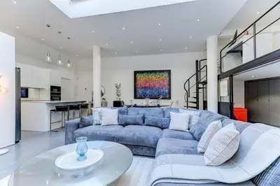 a living room with a blue couch and a table at Magnifique loft au cœur de Nice in Nice