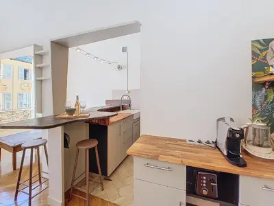 a kitchen with a counter and stools in it at Nestor&Jeeves - CITY TRIP - Central - Balcony in Nice