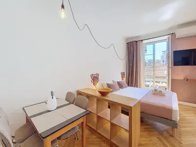 a living room with a dining room table and a dining room gmaxwell gmaxwell at Nestor&Jeeves - CITY TRIP - Central - Balcony in Nice