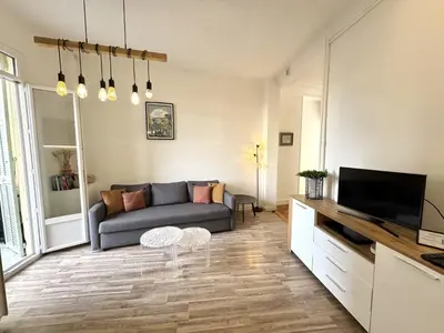 a living room with a couch and a tv at ApartHotel Riviera - TERRASSE HORIZON - 15' Promenade des Anglais in Nice