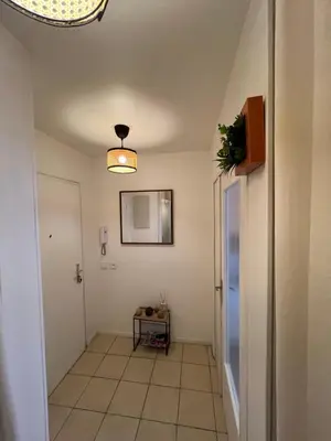 a hallway with a door and a light fixture at Studio proche promenade des anglais in Nice