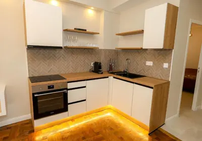 a kitchen with white cabinets and a sink at Nice carré d'or proche Negresco in Nice
