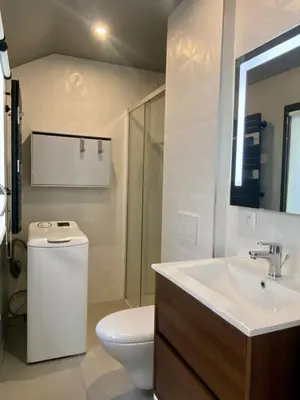 a white bathroom with a toilet and a sink at Studio Beautes FSHH in Nice