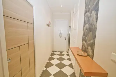 a bathroom with a checkered floor and a wooden bench at Villa Rivoli City Center Nice in Nice