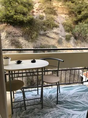 a table and two chairs on a balcony with a view at Le Rabelais, Studio terrasse in Nice