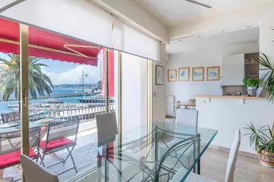 a glass dining room with a view of the ocean at Nice Absea le Port 1 in Nice