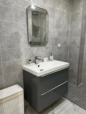 a bathroom with a sink and a mirror at Appartement niçois au coeur du triangle d'or in Nice