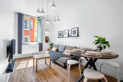 a living room with a table and a couch at Nice Renting - ROSSETTI - Modern Haven Heart of Old Nice in Nice