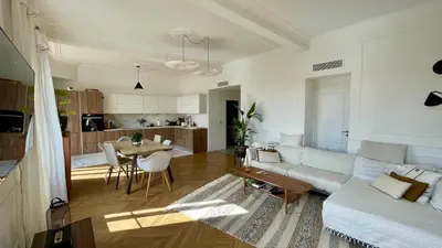 a living room with a couch and a table at Bright, Spacious 2 Bedroom Apartment, Walk to Beach & Old Town in Nice