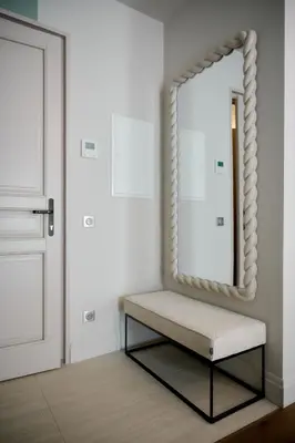a mirror and a bench in front of a door at Aparthotel 9 ALBERTI Nice Centre in Nice