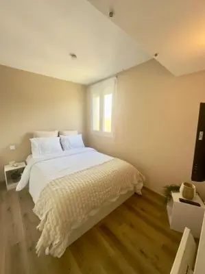 a bedroom with a large white bed and a window at Appartement neuf et rénové promenade des anglais in Nice
