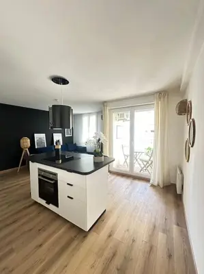 a kitchen with a black counter top in a room at Appartement neuf et rénové promenade des anglais in Nice
