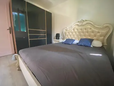 a bedroom with a large bed with blue pillows at Charming house near Center Nice with new air conditioner in Nice