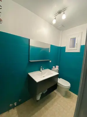 a blue bathroom with a sink and a toilet at Charming house near Center Nice with new air conditioner in Nice