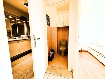 a bathroom with a toilet and a sink at Le St Charles in Saint-Laurent-du-Var