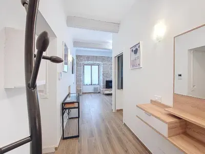 a hallway with white walls and a mirror and a table at Nestor&Jeeves - VILLA FAY - Near Beach - Promenade in Nice