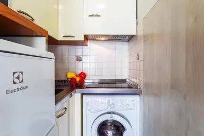 a kitchen with a washing machine in a kitchen at Royal Luxembourg AP4397 By Riviera Holiday Homes in Nice
