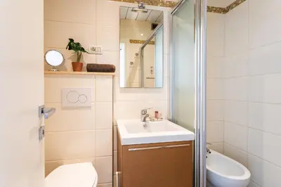 a bathroom with a sink and a toilet and a mirror at Royal Luxembourg AP4397 By Riviera Holiday Homes in Nice