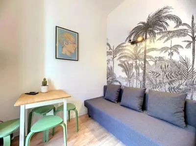 a living room with a couch and a table at All new charming 1br hyper centre with balcony and AC in Nice