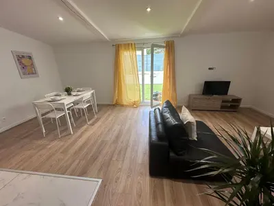 a living room with a couch and a table at appartement au calme avec jardin privatif dans maison in Cagnes-sur-Mer